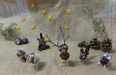 Kastanientiere Verschiedende gebastelte Kastanientiere stehen weihnachtlich dekoriert nebeneinander. Links zwei Schafe, daneben folgen ein Eichhörnchen, ein Hirsch, ein Fuchs und ganz rechts ein Esel.